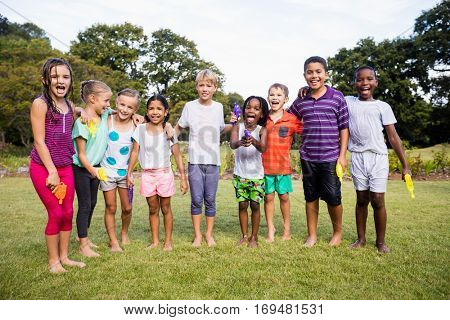 Kids posing together during a sunny day at camera at park