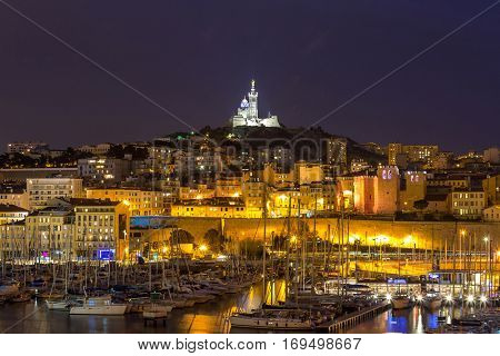 Marseille, France at night. The famous european harbour view on the Notre Dame de la Garde