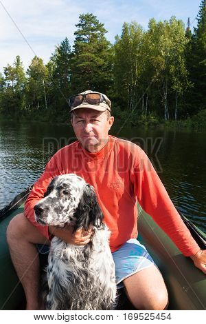 The man in the boat with the setter. Shores of Tagasuk lake, Russia