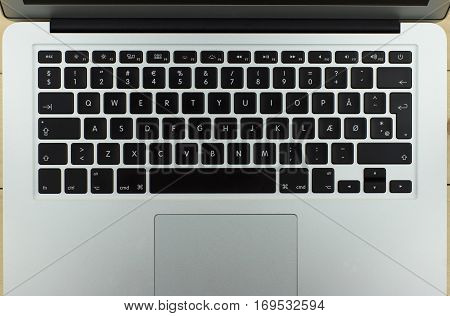 aluminum laptop with a nice design on the wooden background keyboard