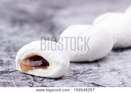 Mochi Japanese dessert with grape flavor closeup on grey background. Selective focus.