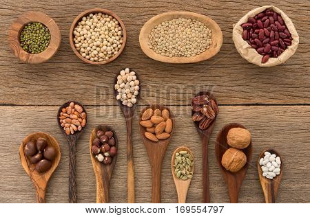 Different Kind Of Beans And Lentils In Wooden Spoon On Wood Background. Mung Bean, Groundnut, Walnut