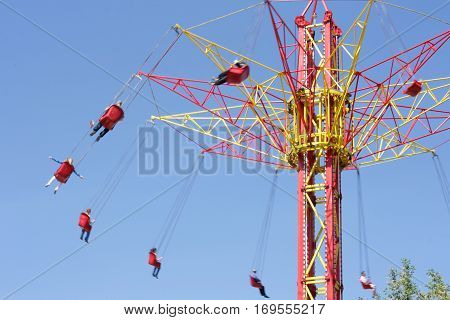 People ride on extreme high carousel tower
