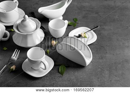 White porcelain tea set on grey table