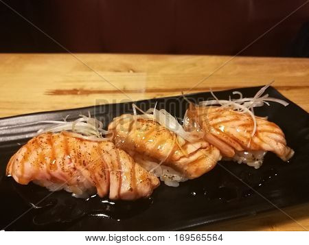 Salmon Sushi with a little burn on top raw food traditional Japanese food