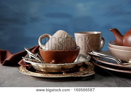 Brown dishware on table and colour background