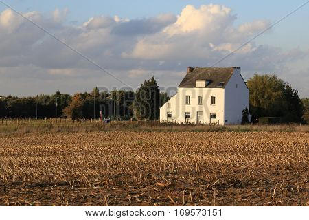 White house in the field, farm house in Belgia