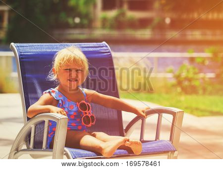 happy cute little girl with sunglasses relax on resort, vacaton concept