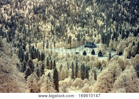Infrared landscape. The tourist lodges in the mountains.