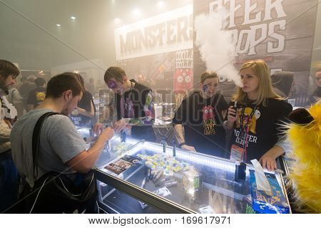 Moscow, Russia - December 9, 2016: People attend Vapexpo Moscow 2016 exhibition which presents new modern vape gadgets, liquids and flawours