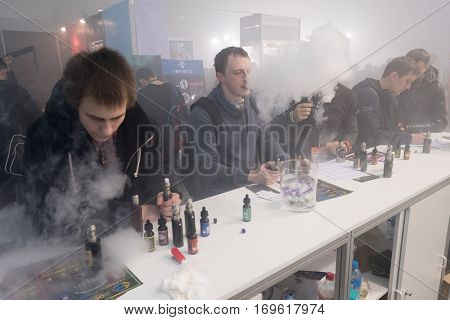 Moscow, Russia - December 9, 2016: People attend Vapexpo Moscow 2016 exhibition which presents new modern vape gadgets, liquids and flawours