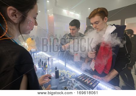 Moscow, Russia - December 9, 2016: People attend Vapexpo Moscow 2016 exhibition which presents new modern vape gadgets, liquids and flawours