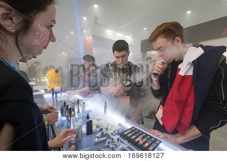 Moscow, Russia - December 9, 2016: People attend Vapexpo Moscow 2016 exhibition which presents new modern vape gadgets, liquids and flawours