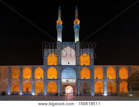 Yazd, Iran - December 17, 2015: Facade of illuminated Amir Chakhmaq mosque at night in Yazd, Iran.