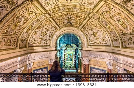 Turin Italy - January 2 2016: woman praying inside Santuario della Consolata in Turin Italy. It is a prominent Marian sanctuary and minor basilica in central Turin Piedmont Italy.