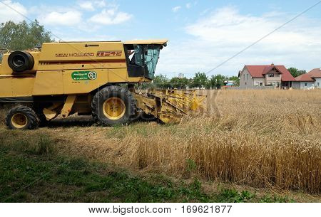 TRNOVEC, CROATIA - JULY 09, 2016: Combine harvester harvest ripe wheat on a farm in Trnovec, Croatia on July 09, 2016