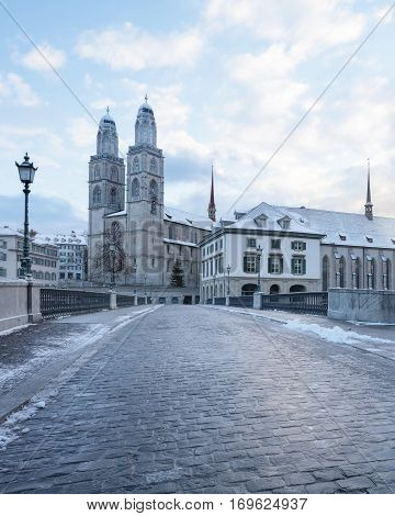 Winter landscape of Zurich. Waldmann monument and Munsterbrucke bridge, Switzerland