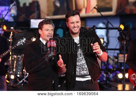 NEW YORK-DEC 31: Recording artist Luke Bryan (R) and host Ryan Seacrest onstage during Dick Clark's New Year's Rockin' Eve at Times Square on December 31, 2015 in New York City.