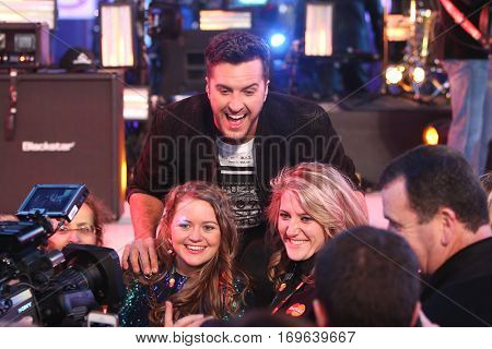 NEW YORK-DEC 31: Recording artist Luke Bryan poses with fans during Dick Clark's New Year's Rockin' Eve at Times Square on December 31, 2015 in New York City.