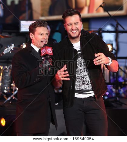 NEW YORK-DEC 31: Recording artist Luke Bryan (R) and Ryan Seacrest onstage during Dick Clark's New Year's Rockin' Eve at Times Square on December 31, 2015 in New York City.