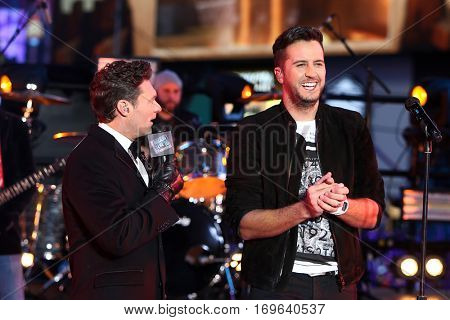 NEW YORK-DEC 31: Recording artist Luke Bryan (R) and Ryan Seacrest onstage during Dick Clark's New Year's Rockin' Eve at Times Square on December 31, 2015 in New York City.