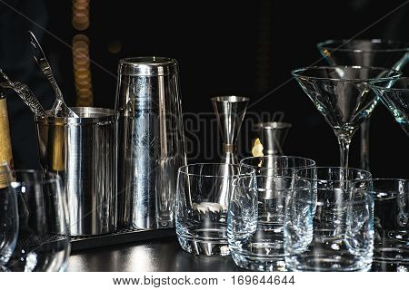 Glasses For A Margarita, Martini, Grog And Liqueur On A Bar At Restaurant, Against The Bar Bar Wall