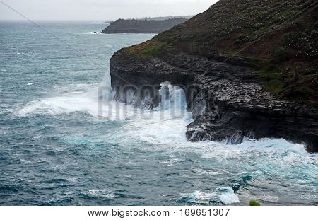 High waves crashing onto the cliffs at Kīlauea Point on Kauai Island Hawaii