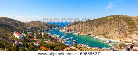 Beautiful view of the Black Sea and the city Balaklava. Balaklava Bay. Genoese fortress in mountains. Clear summer day and a top view of the port