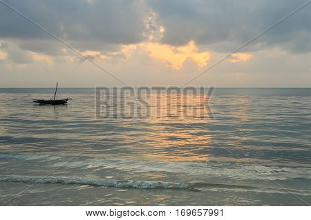 Dhow on the ocean at sunrise on Bamburi beach in Kenya