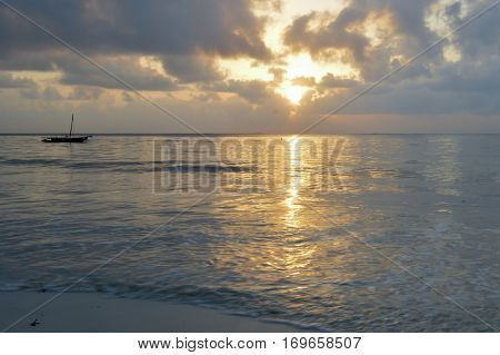 Dhow on the ocean at sunrise on Bamburi beach in Kenya