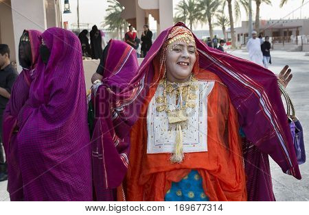 Muscat Oman February 4th 2017: omaniya in traditional dress dancing and showing off her clothes