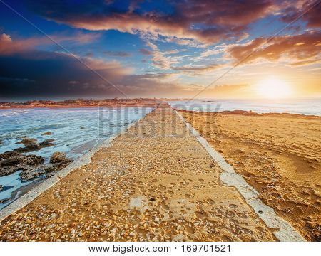 Stone road by the sea, water on both sides