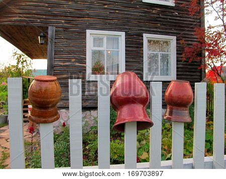 Clay pots on the fence near the village house.