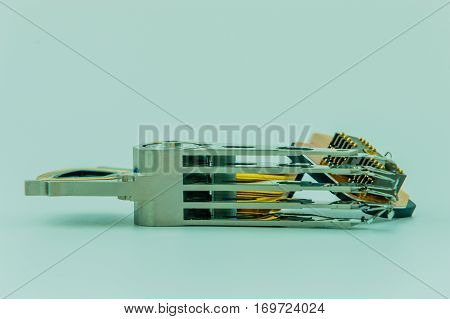 Closeup of a actuator arm and heads from a damaged hard disk drive