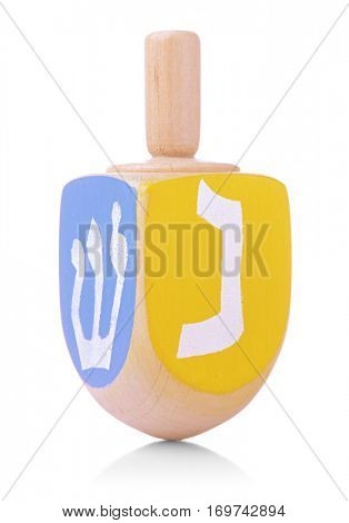 Wooden dreidel for Hanukkah on white background