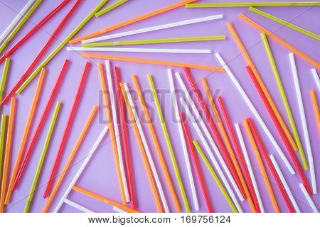 Colorful drinking straws on a pink color background. Abstract a colorful of plastic straws used for drinking water or soft drinks