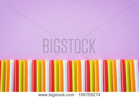 Colorful drinking straws on a pink color background. Abstract a colorful of plastic straws used for drinking water or soft drinks
