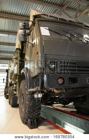 Large military truck in the service station for repair