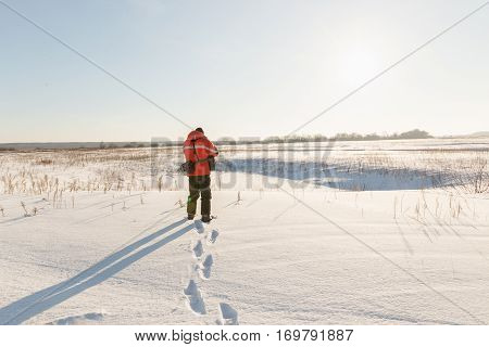 photographer takes winter landscape at dawn in the bitter cold.