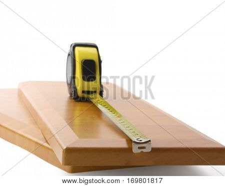 Wooden board and tools on a white background