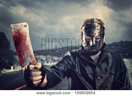 Butcher in hockey mask with bloody meat cleaver