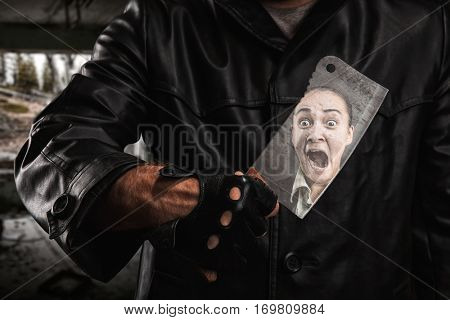 Serial maniac standing under bridge with knife.