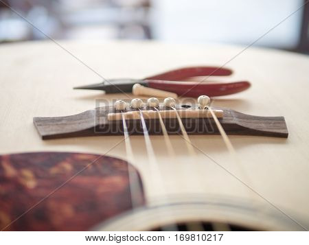 Put the pins and string to acoustic guitar