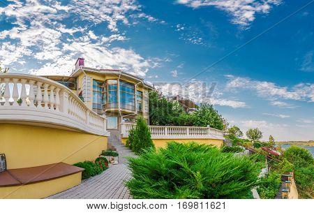 Exterior modern style villa surrounded by nature. Green courtyard