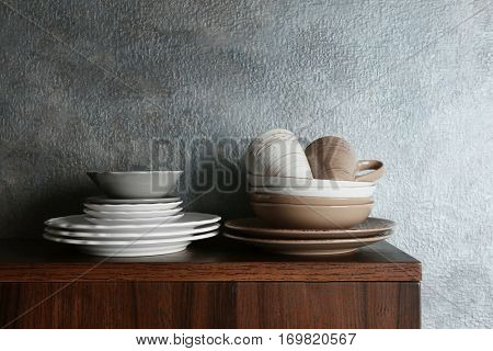 Set of dinnerware on gray background