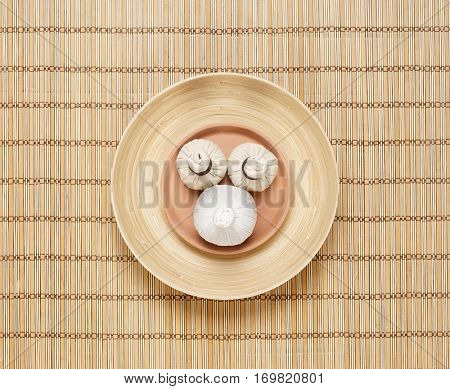 Massage bundles on a plate on bamboo mat. Spa, health, treatment, concept. 