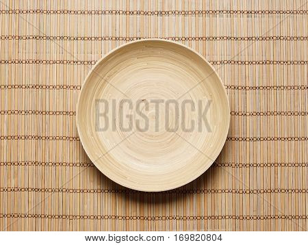 Empty plate on bamboo mat. Health, spa, treatment concept.