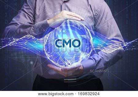 Business, Technology, Internet And Network Concept. Young Businessman Shows The Word: Cmo