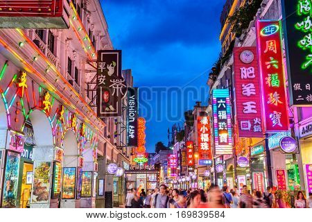 GUANGZHOU, CHINA - MAY 25, 2014: Pedestrians pass through Shangxiajiu Pedestrian Street. The street is the main shopping district of the city and a major tourist attraction.