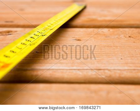 Plastic tape measure on a wooden deck